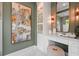 Bathroom vanity featuring stone countertop, white cabinets, and stylish decorative art at 1182 Blue Shell Loop, Sarasota, FL 34240