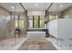 Modern bathroom featuring a freestanding tub, dual showers, and a neutral color palette at 1182 Blue Shell Loop, Sarasota, FL 34240