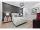 Cozy bedroom with an accent wall, stylish light fixture, and a large window at 1182 Blue Shell Loop, Sarasota, FL 34240