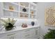 Butler's pantry featuring built-in shelving, sleek cabinets, and stylish decor at 1182 Blue Shell Loop, Sarasota, FL 34240