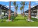 An outdoor community lawn area with trees in the middle of covered spaces at 1182 Blue Shell Loop, Sarasota, FL 34240