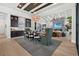 Elegant dining area with adjacent bar and living room has a large rug and sleek modern fireplace at 1182 Blue Shell Loop, Sarasota, FL 34240