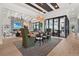 Bright dining area and Gathering room with fireplace, soaring ceilings, and sliding doors to water view at 1182 Blue Shell Loop, Sarasota, FL 34240