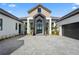 Beautiful home exterior with a brick driveway, landscaped yard, a well manicured lawn and mature palm trees at 1182 Blue Shell Loop, Sarasota, FL 34240