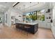 Spacious kitchen featuring a large center island with seating, modern appliances, and bright natural light at 1182 Blue Shell Loop, Sarasota, FL 34240