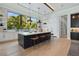 Spacious kitchen featuring a large island, modern lighting, and views to the outdoors at 1182 Blue Shell Loop, Sarasota, FL 34240