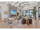 Bright living room boasts fireplace, soaring ceilings with exposed beams, and expansive window with water view at 1182 Blue Shell Loop, Sarasota, FL 34240