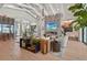 Large living room with a decorative fireplace, beamed ceilings, a wine cellar and floor to ceiling windows at 1182 Blue Shell Loop, Sarasota, FL 34240