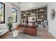 Home office featuring custom built-ins, a modern desk, and lots of natural light at 1182 Blue Shell Loop, Sarasota, FL 34240