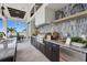 Modern outdoor kitchen equipped with premium grill, stylish cabinetry, and scenic water views at 1182 Blue Shell Loop, Sarasota, FL 34240