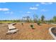 A modern playground features swings, wooden balance beams and other structures in a Gathering-friendly neighborhood at 1182 Blue Shell Loop, Sarasota, FL 34240