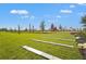 Expansive community playground area featuring lush green grass and play structures at 1182 Blue Shell Loop, Sarasota, FL 34240