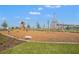 A community playground with a variety of wooden structures offers a recreational space for outdoor fun and Gathering time at 1182 Blue Shell Loop, Sarasota, FL 34240