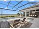 Lounge by the covered pool and hot tub with a water view and enjoy outdoor entertaining at the bar at 1182 Blue Shell Loop, Sarasota, FL 34240