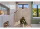 Walk-in shower with sleek fixtures, a comfortable bench, and a decorative niche at 1182 Blue Shell Loop, Sarasota, FL 34240