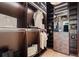 Modern walk-in closet with wood-grain cabinets, soft lighting, and plenty of storage at 1182 Blue Shell Loop, Sarasota, FL 34240