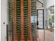 A wall of wine bottles are showcased through glass in this contemporary home at 1182 Blue Shell Loop, Sarasota, FL 34240