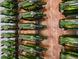 Unique modern wine storage rack with green bottles against a wood background, adding elegance and sophistication at 1182 Blue Shell Loop, Sarasota, FL 34240