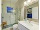 Updated bathroom with glass shower, mosaic tile, and white marble vanity for a modern aesthetic at 12175 Maple Ridge Dr, Parrish, FL 34219
