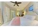 Bright bedroom with a white four-poster bed, serene decor, and natural light at 12175 Maple Ridge Dr, Parrish, FL 34219