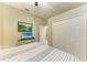 Bedroom featuring a closet and dresser with a television, ceiling fan, and neutral color palette at 12175 Maple Ridge Dr, Parrish, FL 34219