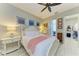 Well-lit bedroom features a white four-poster bed, and access to a walk-in closet at 12175 Maple Ridge Dr, Parrish, FL 34219