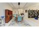 Open dining room with seating for eight, stylish rug, and wine storage at 12175 Maple Ridge Dr, Parrish, FL 34219