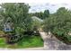 Well-maintained home featuring mature trees, manicured lawn, and a welcoming driveway with enhanced curb appeal at 12175 Maple Ridge Dr, Parrish, FL 34219