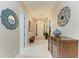Elegant hallway featuring light wood floors, decorative mirror and sconces at 12175 Maple Ridge Dr, Parrish, FL 34219