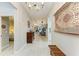 Inviting hallway with wood-look tile, decorative wall hangings, and views into other living spaces at 12175 Maple Ridge Dr, Parrish, FL 34219