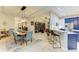Open concept kitchen with white cabinets, bar seating and view into dining area at 12175 Maple Ridge Dr, Parrish, FL 34219