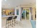 Kitchen bar with seating and large glass doors leading to outdoor patio at 12175 Maple Ridge Dr, Parrish, FL 34219