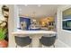 Kitchen bar offers seating with a view to the kitchen and comfortable living room at 12175 Maple Ridge Dr, Parrish, FL 34219