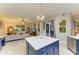 Bright kitchen with island seating overlooking the living room with outdoor views at 12175 Maple Ridge Dr, Parrish, FL 34219