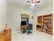 Home office with a wooden desk, bookshelf, and a window offering natural light at 12175 Maple Ridge Dr, Parrish, FL 34219