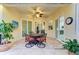Cozy outdoor patio with tiled flooring, ceiling fan, and comfortable seating, perfect for relaxation and dining at 12175 Maple Ridge Dr, Parrish, FL 34219