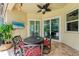 Charming outdoor patio area featuring a stylish table set, ceiling fan, and serene views for al fresco dining at 12175 Maple Ridge Dr, Parrish, FL 34219