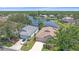 Aerial view of lakeside homes showcasing serene water views and a desirable neighborhood at 12322 Tall Pines Way, Lakewood Ranch, FL 34202