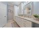 Well-lit bathroom featuring double sinks, modern cabinetry, and stylish mirrors at 12322 Tall Pines Way, Lakewood Ranch, FL 34202