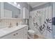 Bright bathroom with a white vanity, decorative shower curtain, and modern fixtures at 12322 Tall Pines Way, Lakewood Ranch, FL 34202