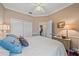 Well-lit bedroom featuring a double door closet, wall art, and doorway leading to another room at 12322 Tall Pines Way, Lakewood Ranch, FL 34202