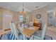 Elegant dining room with a wooden table, chandelier, and neutral color palette at 12322 Tall Pines Way, Lakewood Ranch, FL 34202
