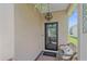 Inviting front porch with a decorative light fixture, welcome mat, and comfortable seating at 12322 Tall Pines Way, Lakewood Ranch, FL 34202