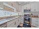 Well-equipped kitchen with granite countertops, stainless steel appliances, and white cabinetry at 12322 Tall Pines Way, Lakewood Ranch, FL 34202