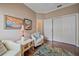 Comfortable living room featuring seating, artwork, and access to a closet and doorway at 12322 Tall Pines Way, Lakewood Ranch, FL 34202