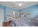 Airy main bedroom featuring wicker furnishings, blue walls, and a peek into the bathroom at 12322 Tall Pines Way, Lakewood Ranch, FL 34202