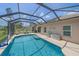 Screened-in swimming pool with patio area, outdoor seating, and lush landscaping at 12322 Tall Pines Way, Lakewood Ranch, FL 34202