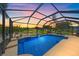 Sparkling screened-in pool offers stunning water views and lounge area for relaxation and outdoor enjoyment at 12322 Tall Pines Way, Lakewood Ranch, FL 34202
