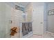 Modern walk-in shower with marble tile, glass door, and a built-in bench at 12322 Tall Pines Way, Lakewood Ranch, FL 34202
