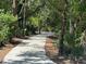 Walking path meandering through a peaceful wooded area at 12322 Tall Pines Way, Lakewood Ranch, FL 34202